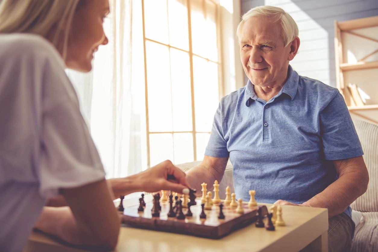 Photo of an old man playing chess